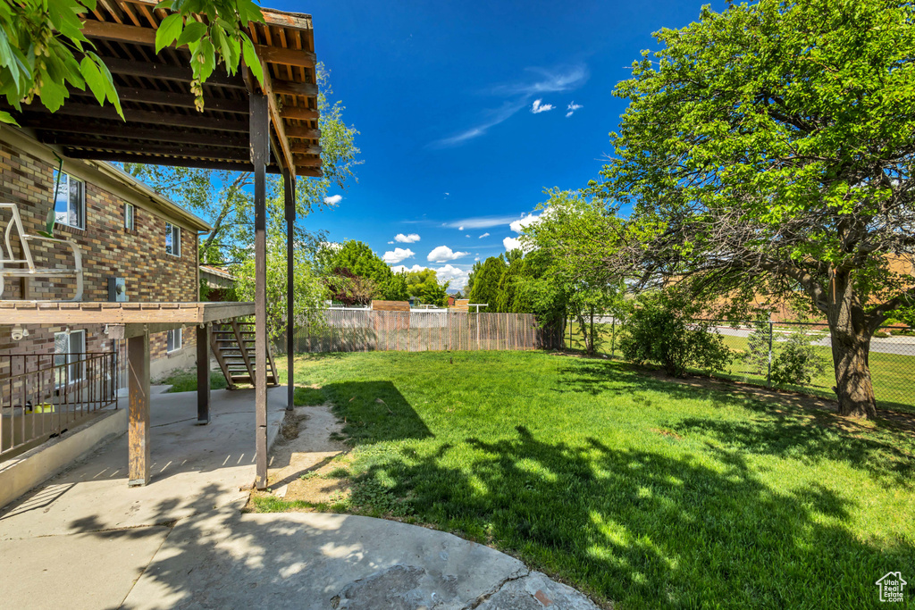 View of yard with stairs and a patio