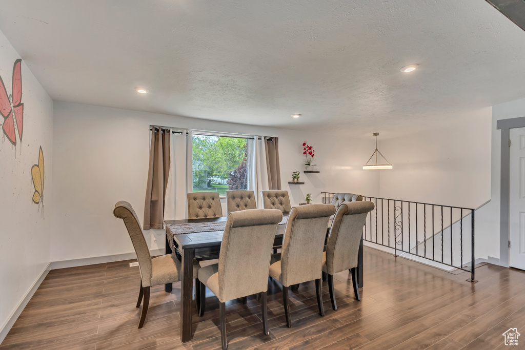 Dining area with dark wood-style floors, baseboards, and recessed lighting