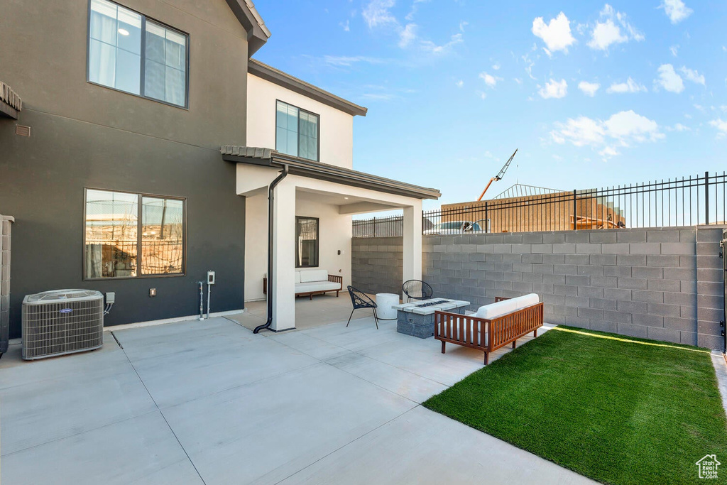 View of patio / terrace with central air condition unit and an outdoor living space with a fire pit