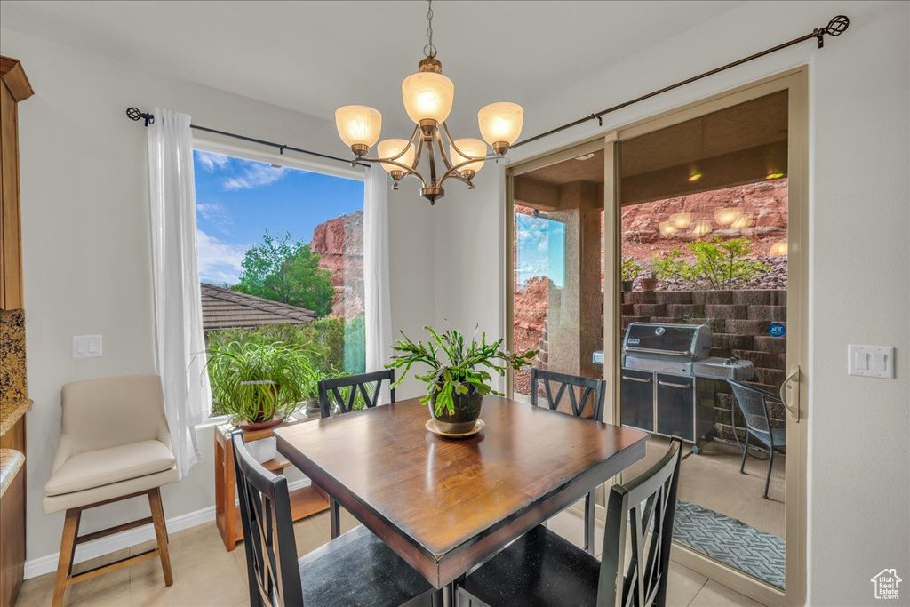 Dining room featuring a chandelier and baseboards
