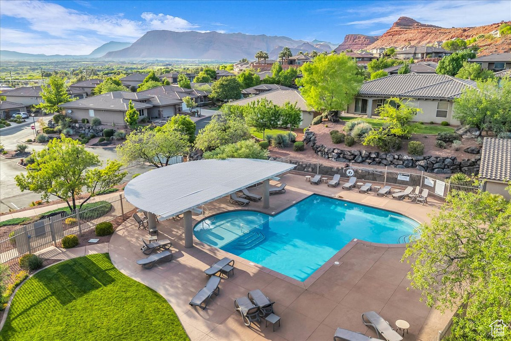 Community pool featuring a residential view, a patio area, and a mountain view