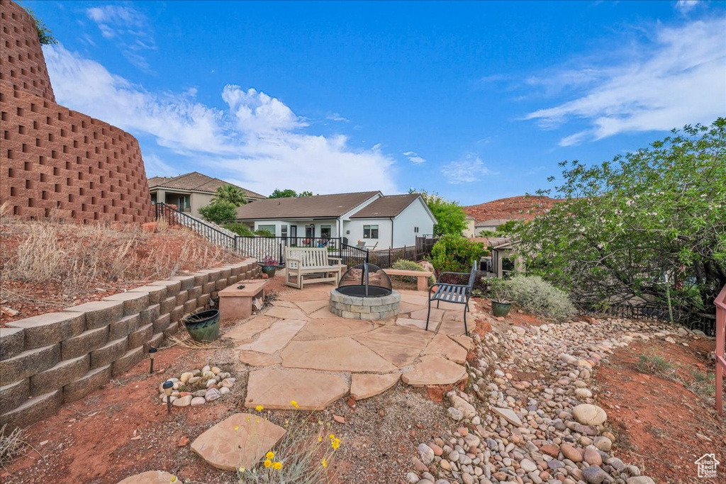 View of patio / terrace with a fire pit and fence