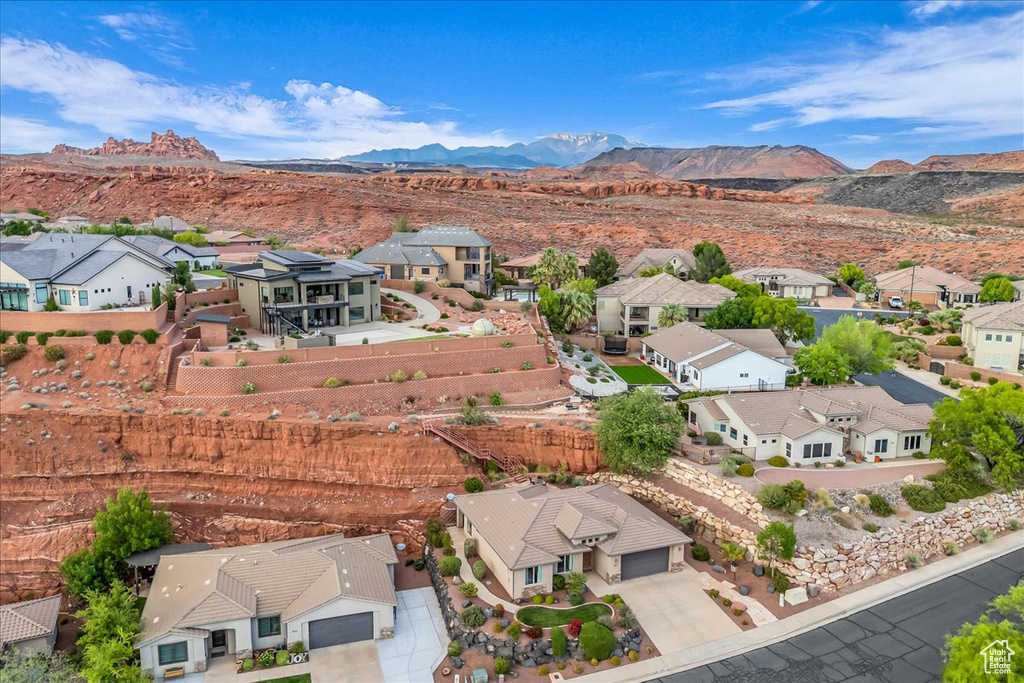 Aerial view of residential area featuring a mountainous background