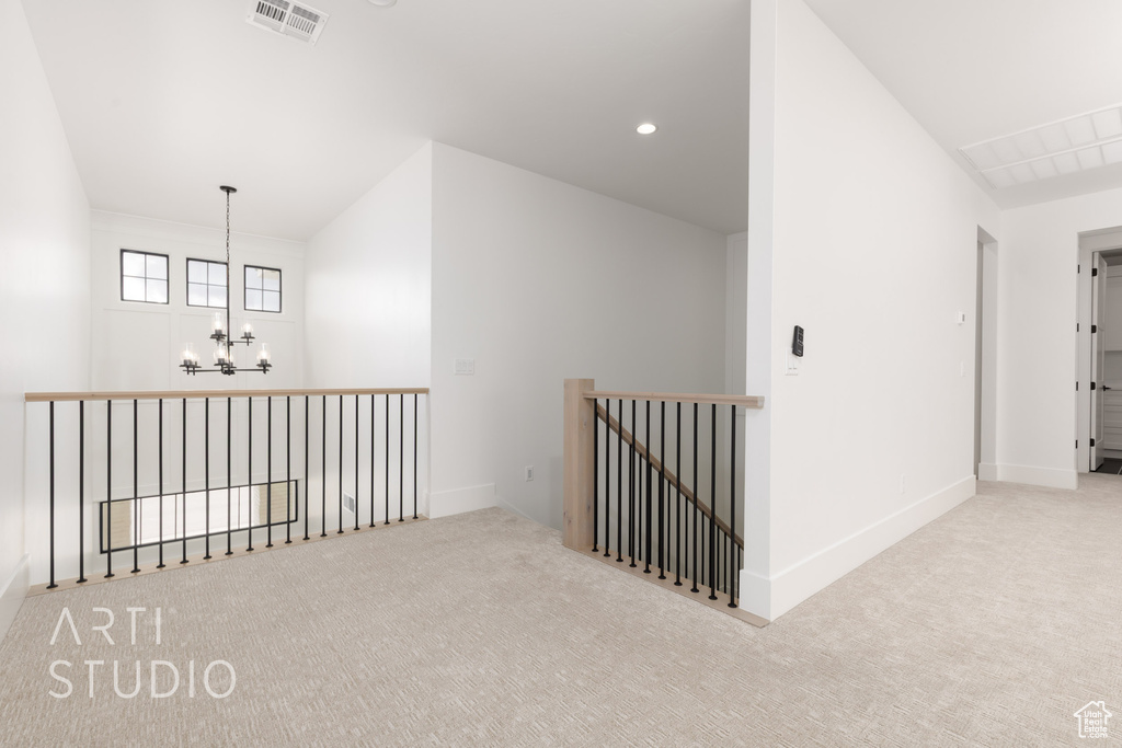 Hallway with a chandelier, carpet floors, baseboards, an upstairs landing, and recessed lighting