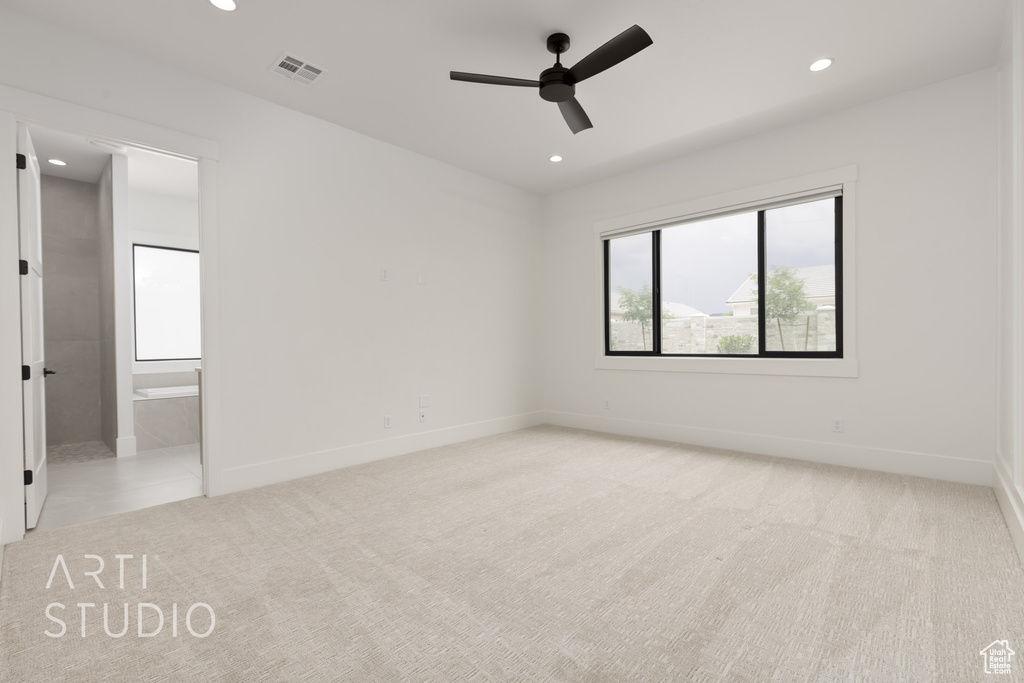 Unfurnished bedroom with light carpet, recessed lighting, baseboards, ensuite bathroom, and a ceiling fan