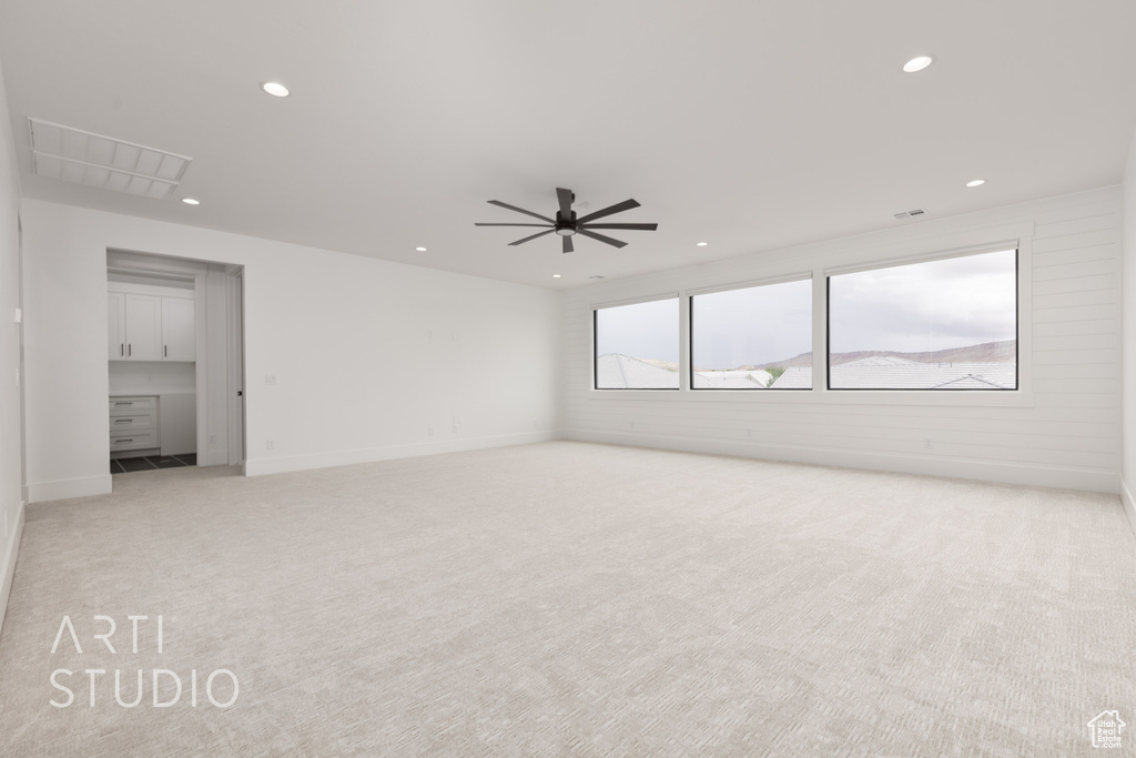 Unfurnished room featuring light carpet, recessed lighting, and a ceiling fan