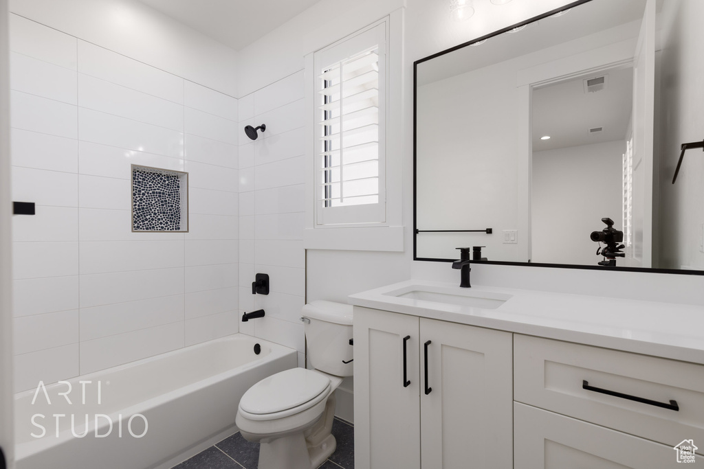 Full bathroom with toilet, vanity, washtub / shower combination, and tile patterned floors
