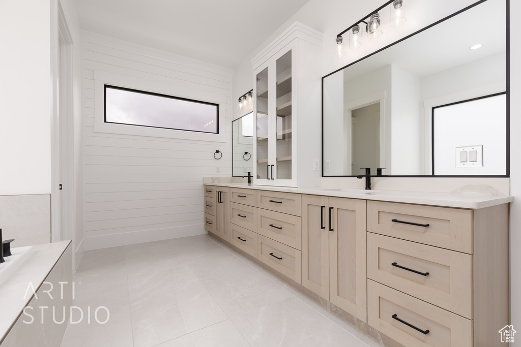 Full bath with double vanity and marble look tile flooring