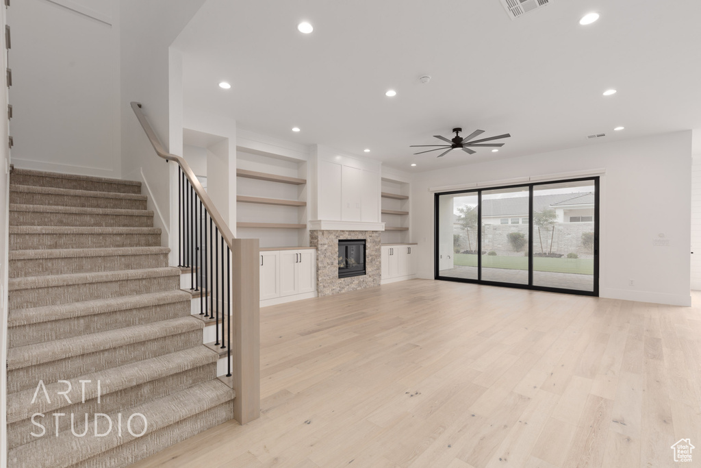 Unfurnished living room featuring recessed lighting, a ceiling fan, baseboards, stairway, and light wood-style flooring