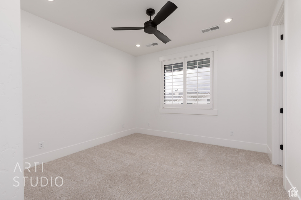 Carpeted spare room with a ceiling fan, recessed lighting, and baseboards