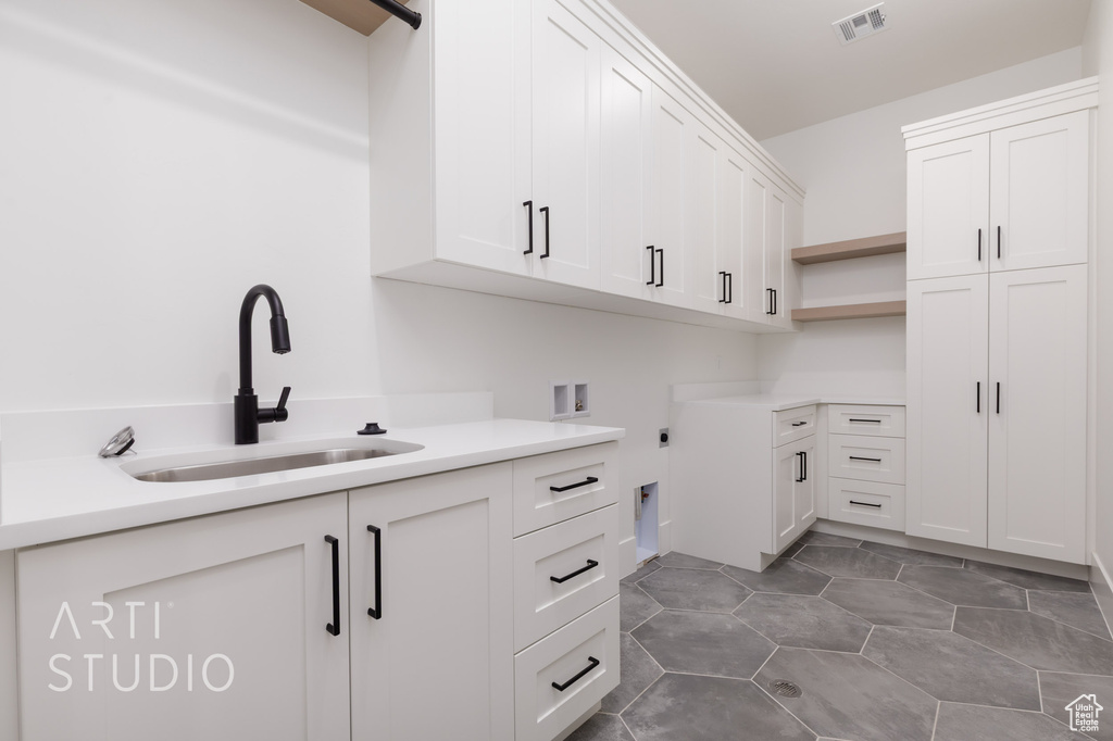 Washroom featuring cabinet space, electric dryer hookup, and hookup for a washing machine