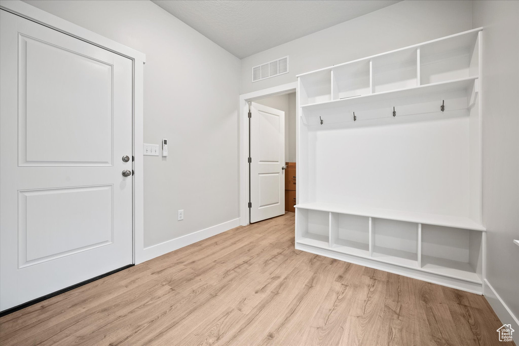 Mudroom with baseboards and light wood-style floors