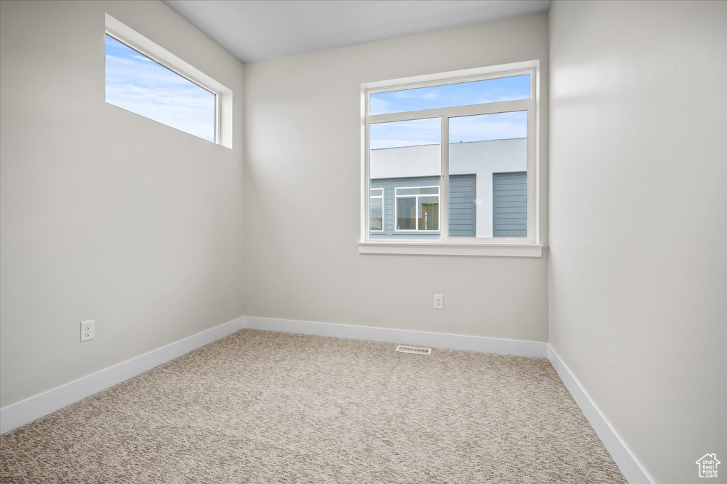 Carpeted spare room with baseboards