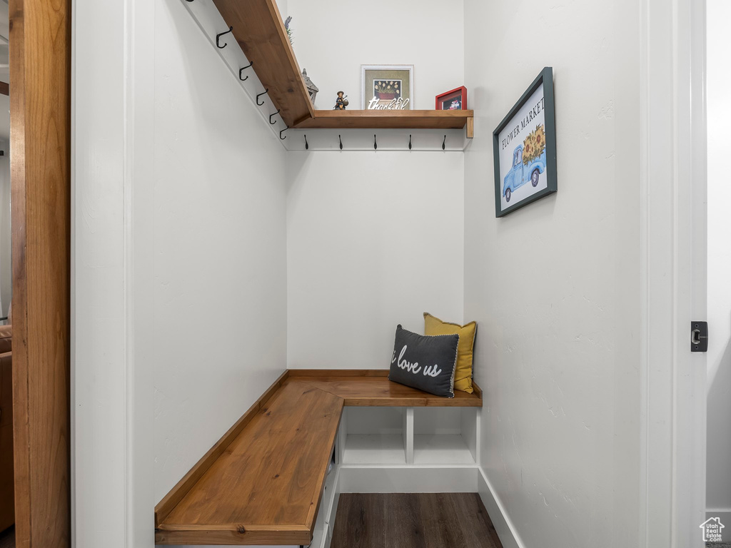 Mudroom featuring dark wood-type flooring and baseboards