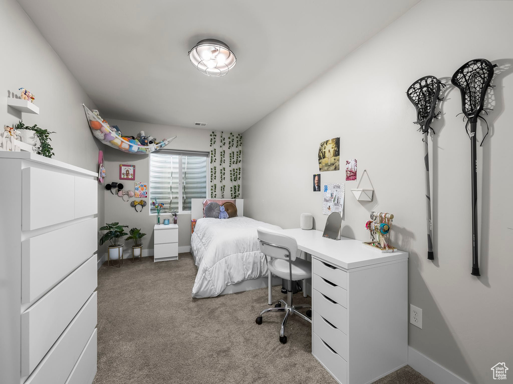 Bedroom featuring carpet and an office area