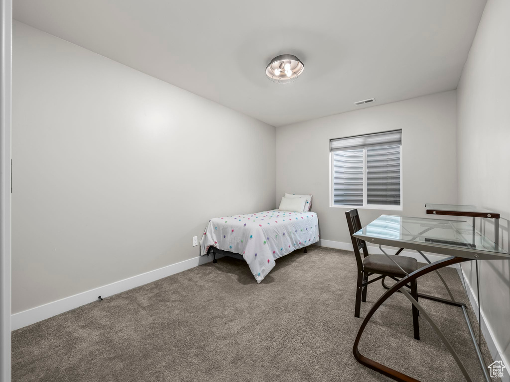Bedroom with baseboards and carpet floors