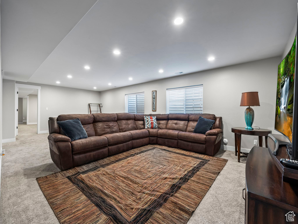 Living room with light carpet, recessed lighting, and baseboards