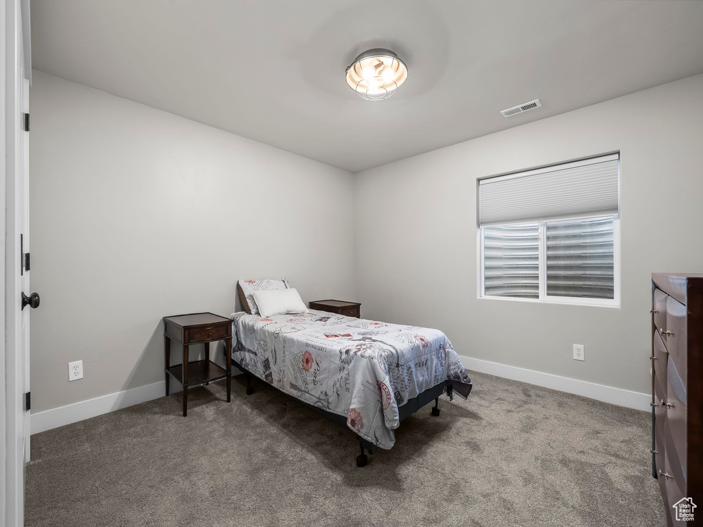 Bedroom featuring baseboards and carpet flooring