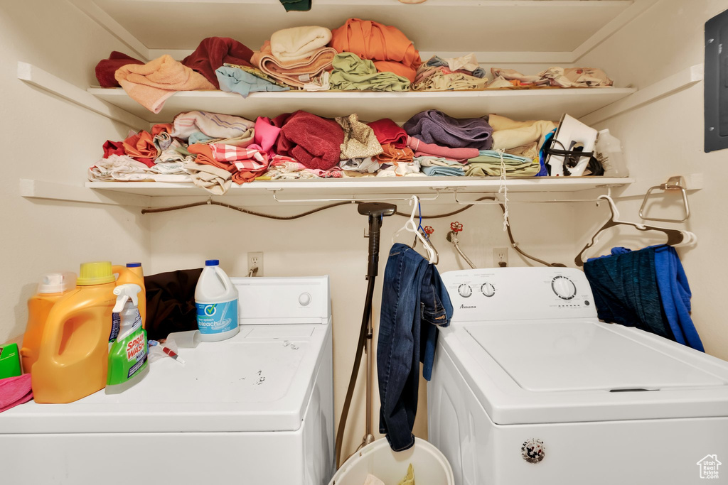 Washroom featuring independent washer and dryer and electric panel