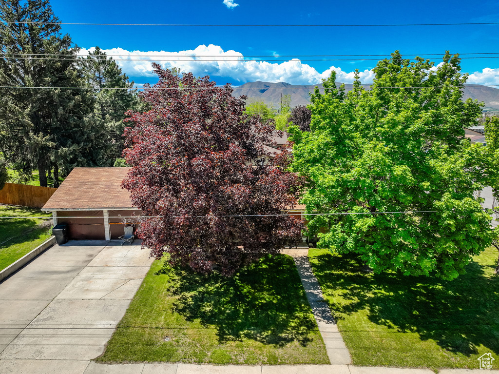 View of front facade featuring a mountain view and concrete driveway