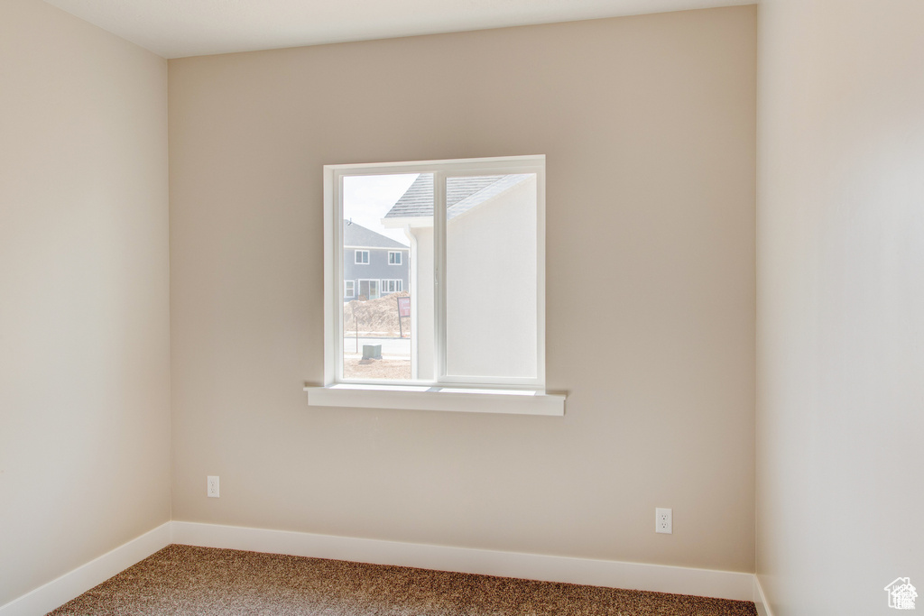 Unfurnished room featuring carpet floors and baseboards