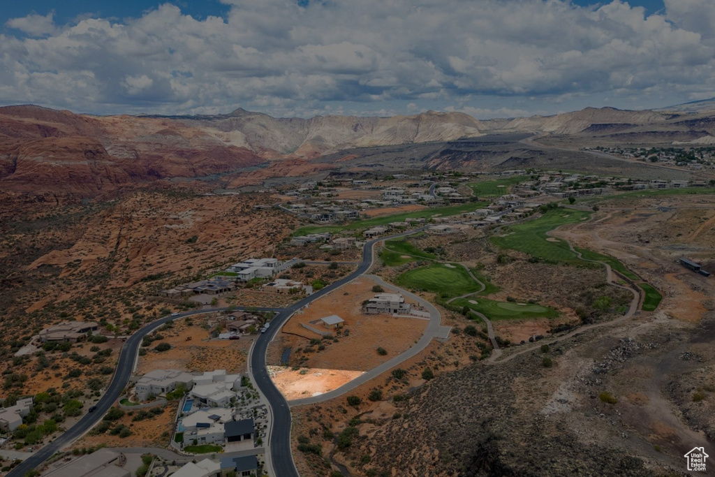 Aerial view of property and surrounding area featuring a mountainous background