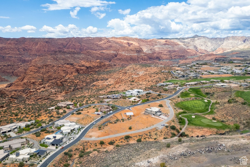 Aerial view of property's location featuring a mountainous background and nearby suburban area