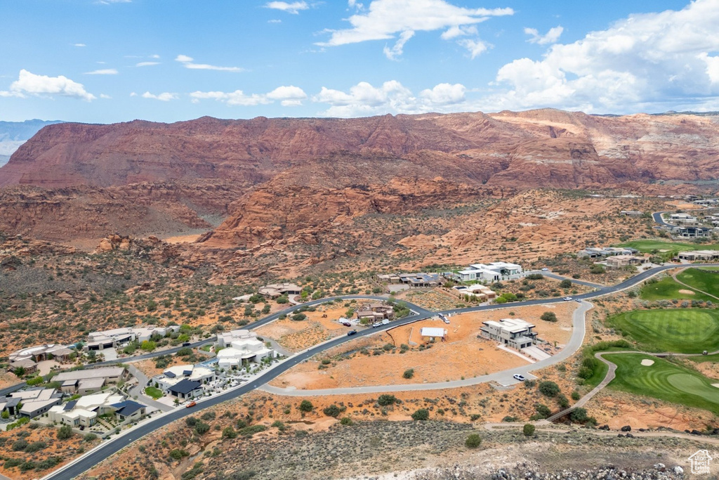 Aerial overview of property's location featuring mountains, a local golf course, and nearby suburban area
