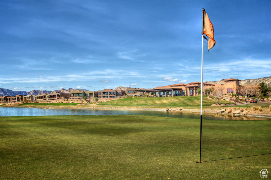View of property's community featuring a water view, a yard, and a residential view