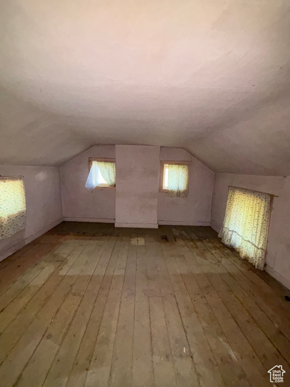 Bonus room featuring light wood-type flooring and lofted ceiling