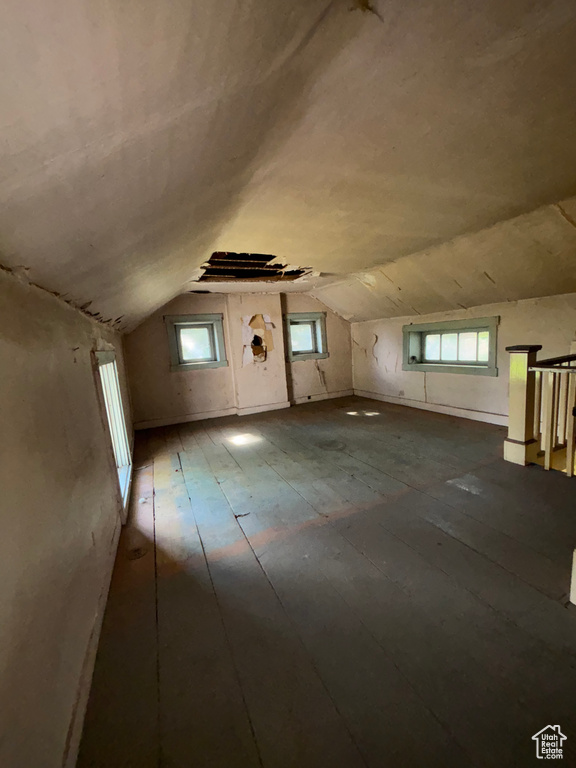 Additional living space featuring plenty of natural light, lofted ceiling, and wood-type flooring
