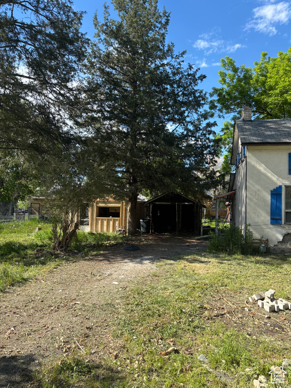 View of yard with a carport and driveway