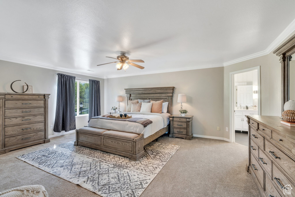 Bedroom with light carpet, ornamental molding, ensuite bathroom, baseboards, and ceiling fan