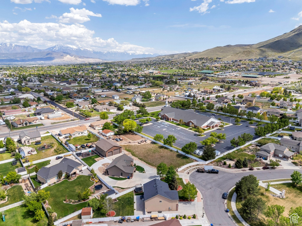 Aerial view of property's location with mountains and nearby suburban area