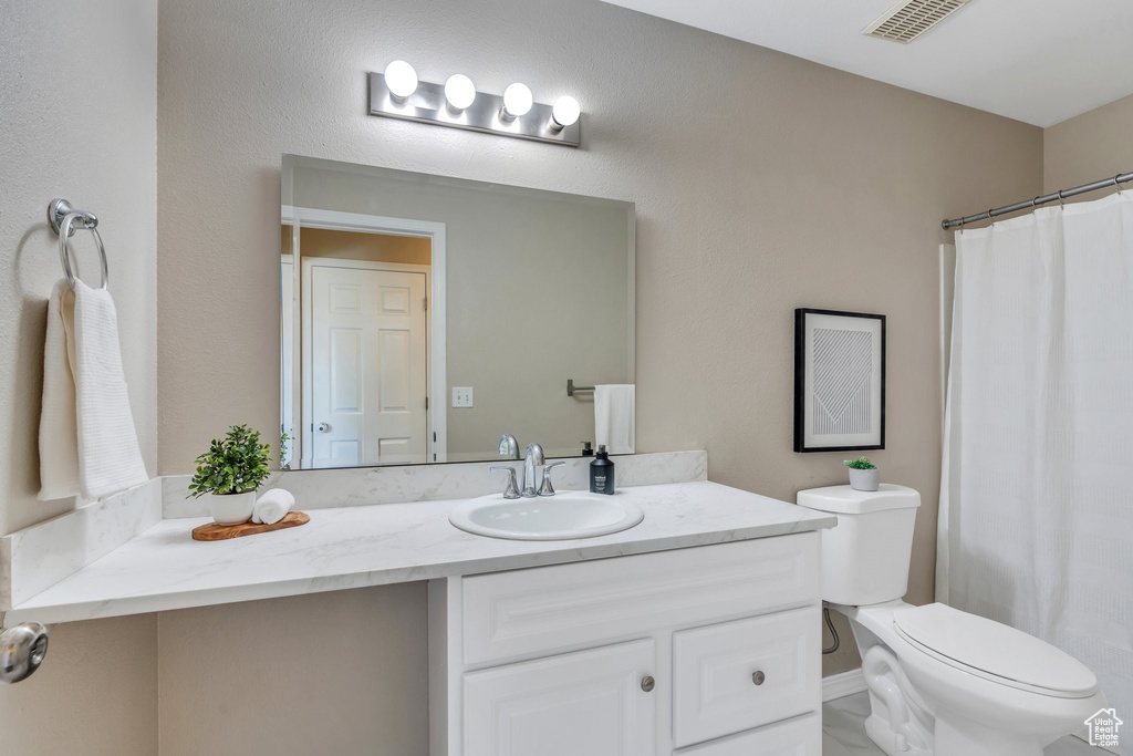 Full bathroom featuring vanity and toilet