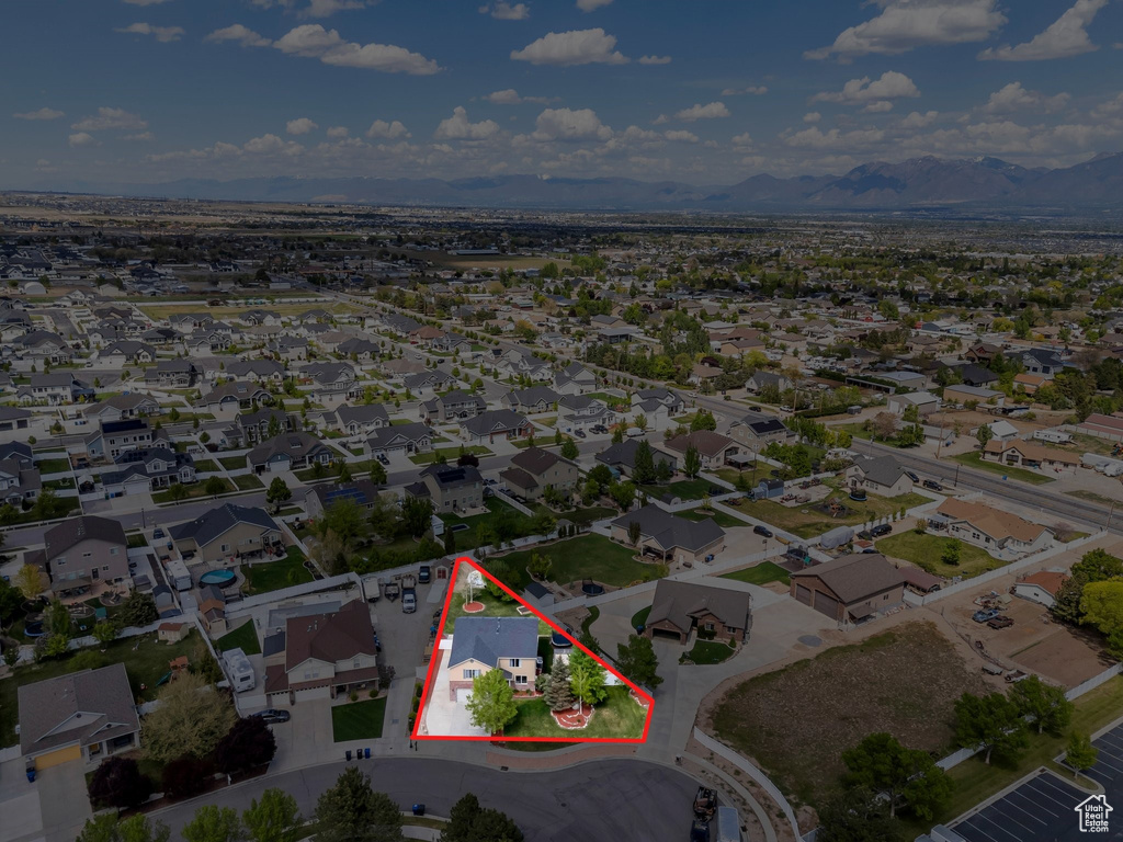 Aerial view of property's location featuring property boundaries highlighted, a mountain backdrop, and nearby suburban area