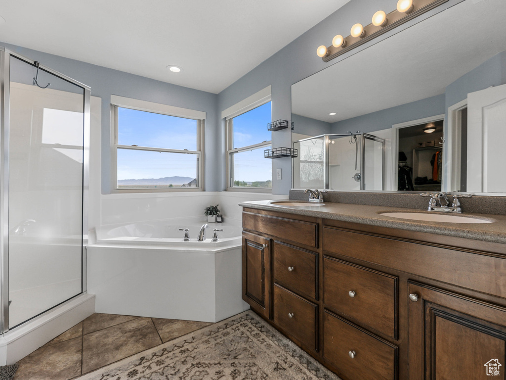 Full bathroom with a shower stall, a garden tub, double vanity, tile patterned floors, and recessed lighting