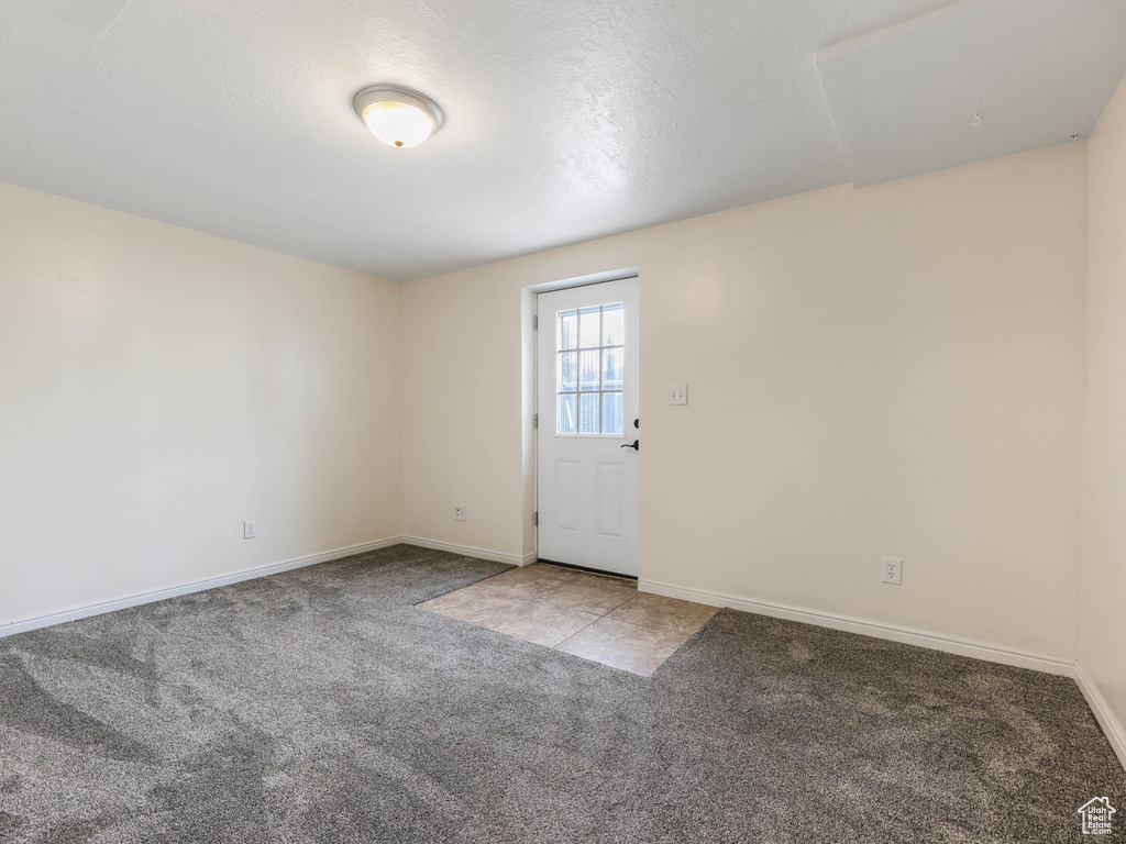 Carpeted empty room with baseboards