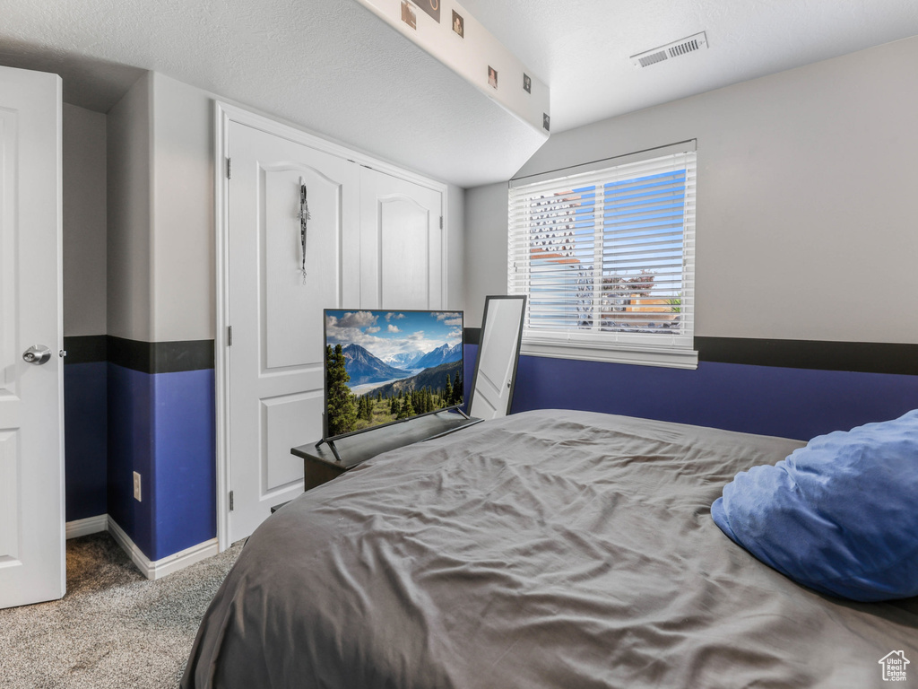 Carpeted bedroom with baseboards
