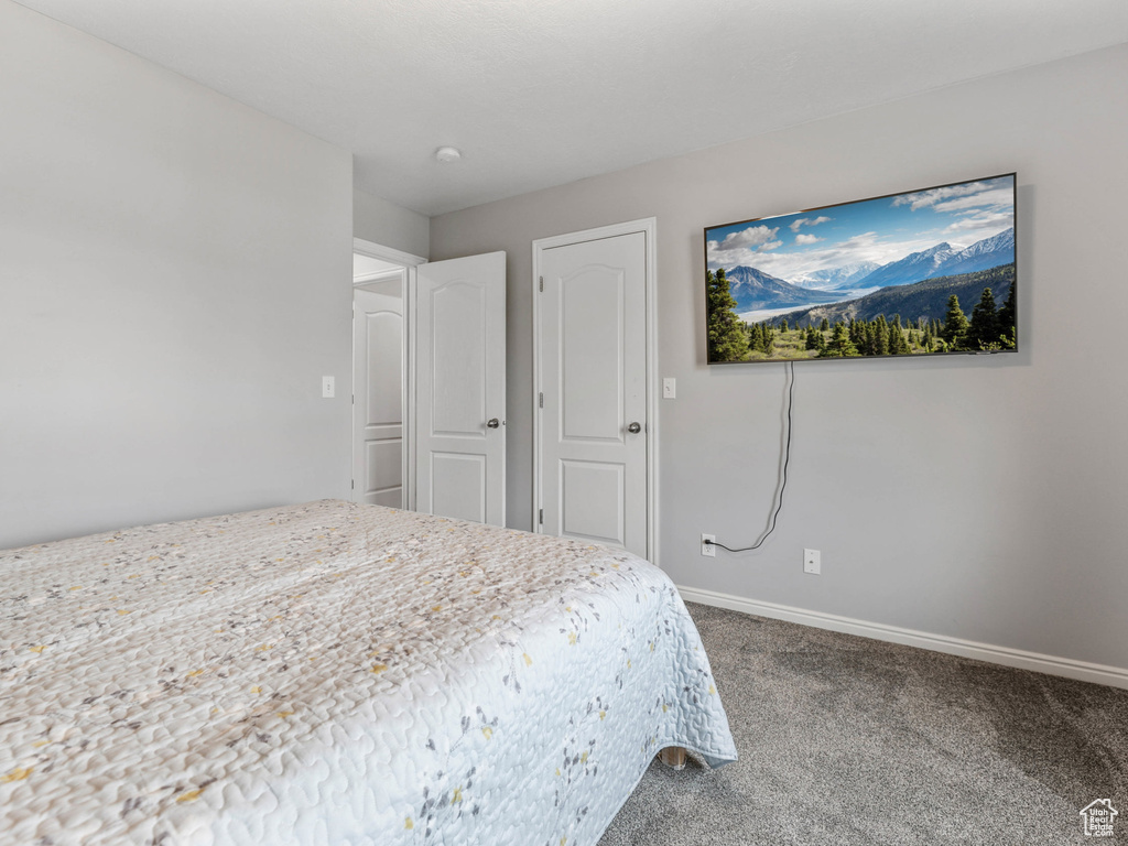 Carpeted bedroom with baseboards