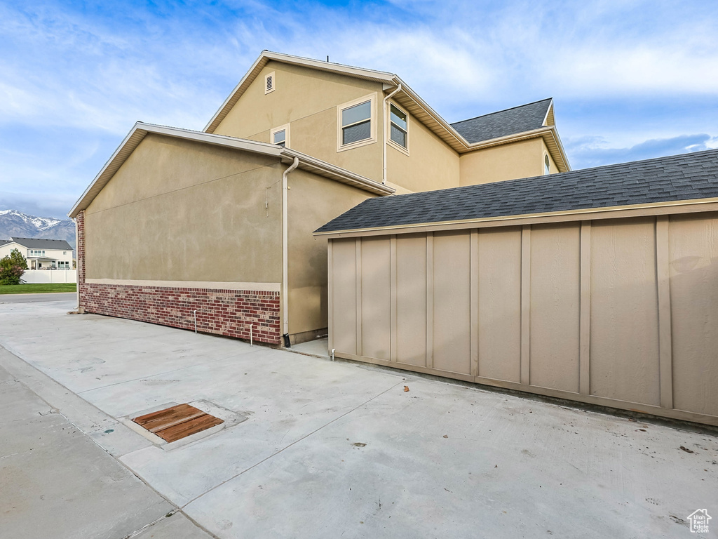 View of property exterior with a patio and stucco siding