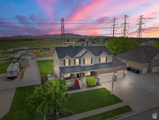 View of front of house featuring a porch, concrete driveway, and a garage