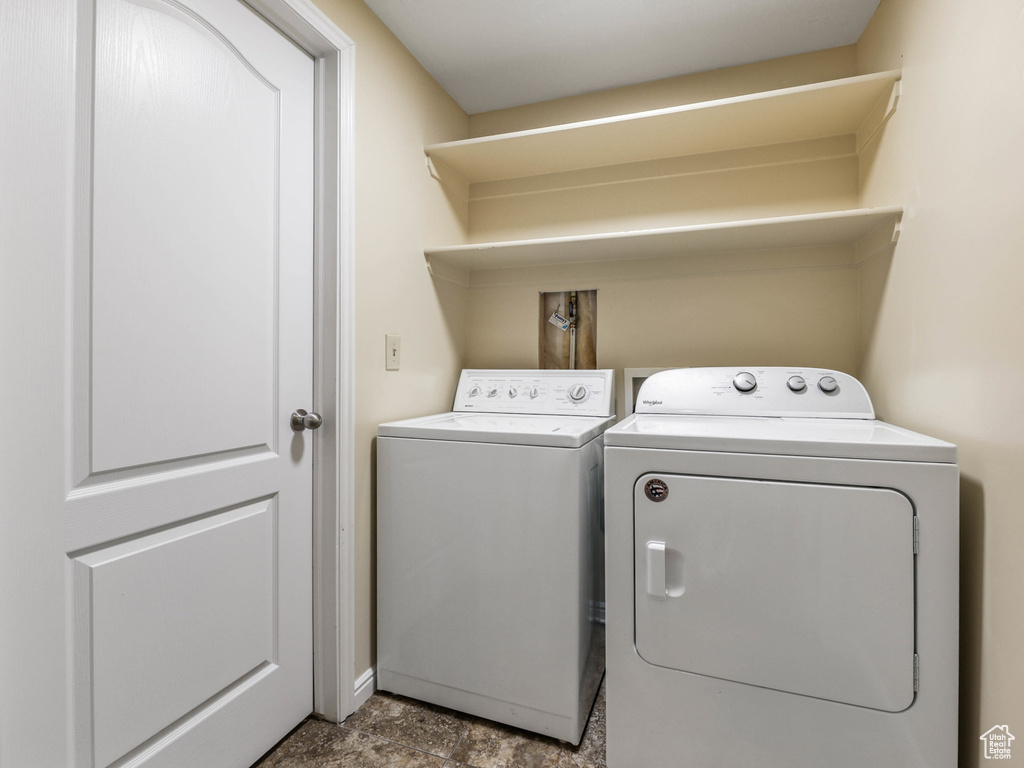 Washroom featuring separate washer and dryer and baseboards