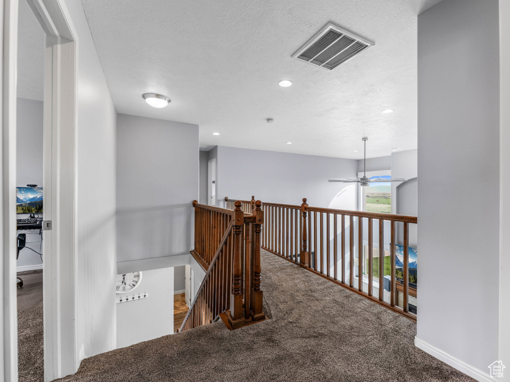 Hall featuring carpet floors, an upstairs landing, and recessed lighting