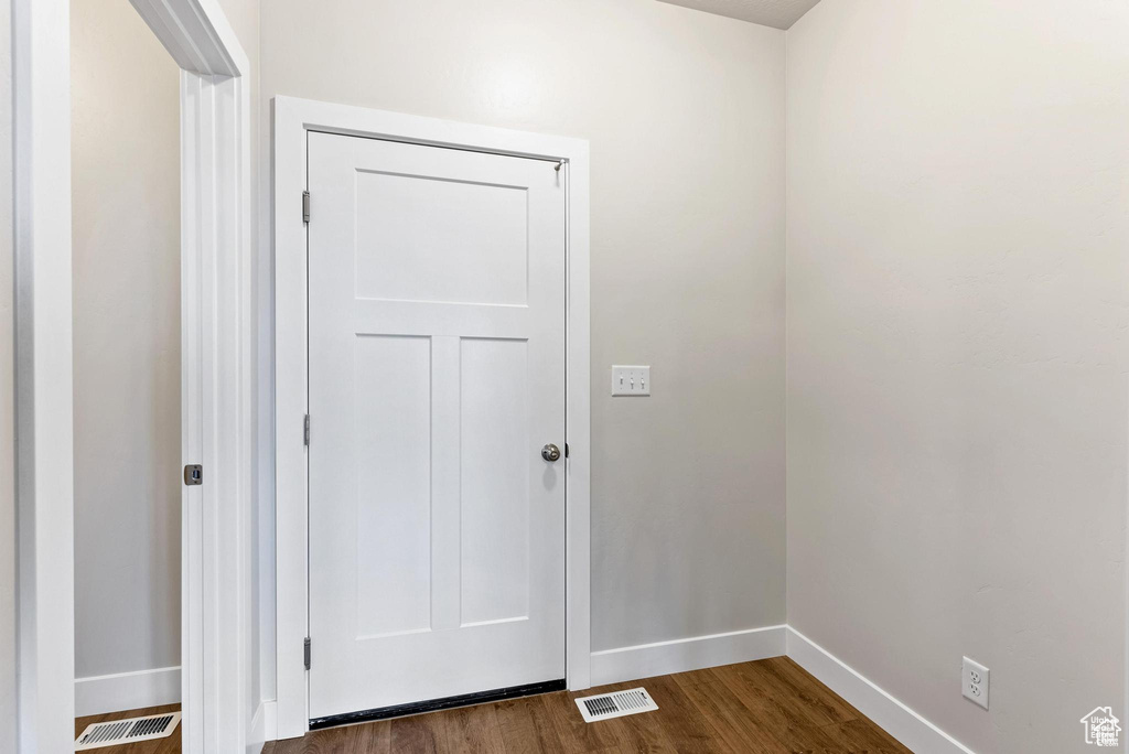 Doorway to outside featuring dark wood finished floors and baseboards