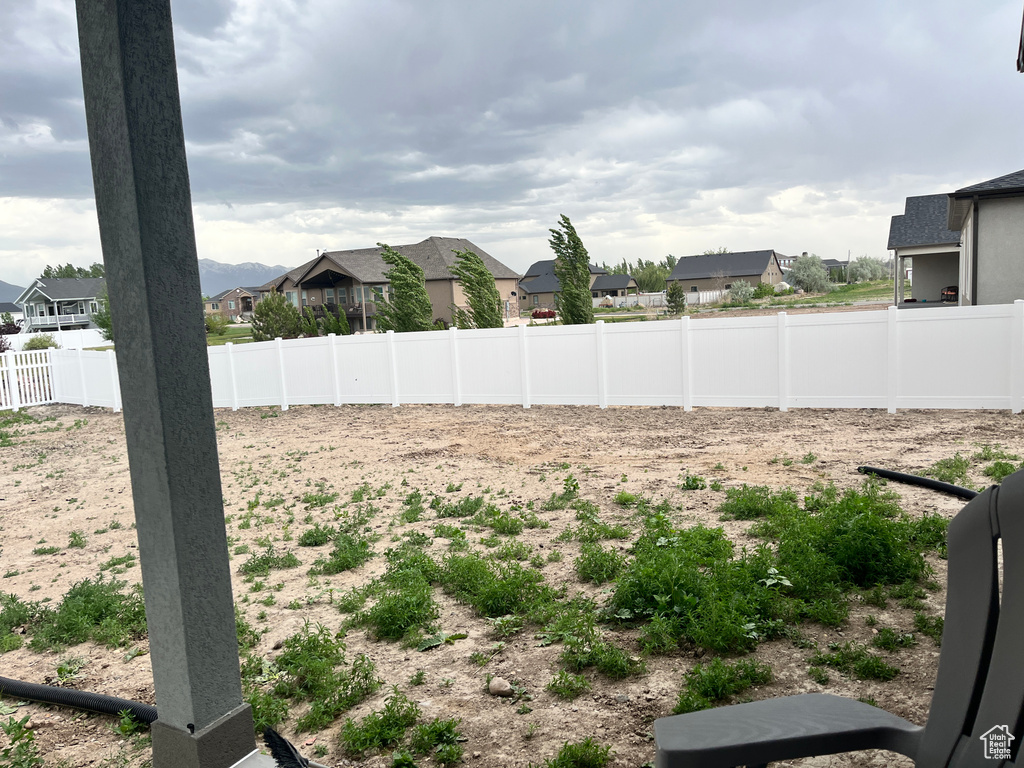 View of yard with a residential view and fence