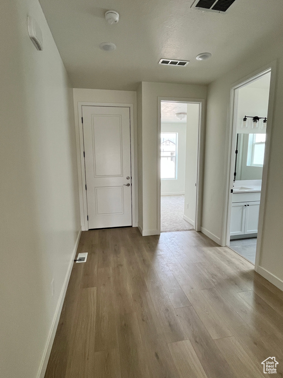 Hallway with baseboards and wood finished floors