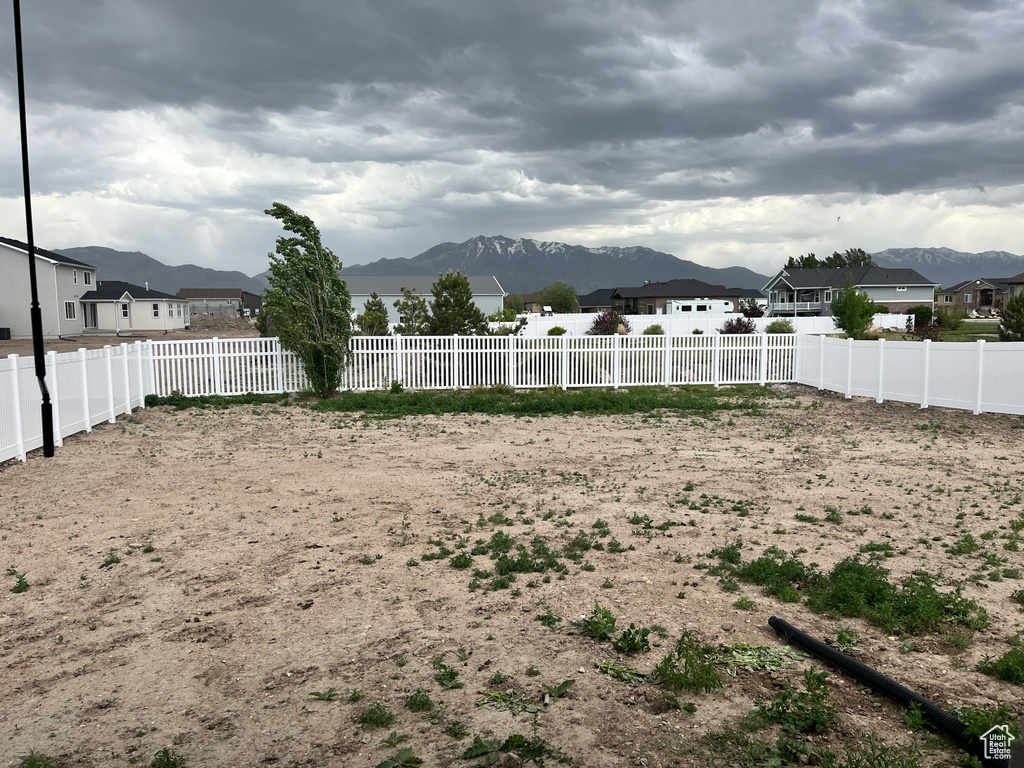 Fenced backyard with a mountain view and a residential view