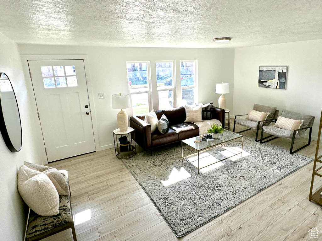 Living area with a textured ceiling and wood finished floors