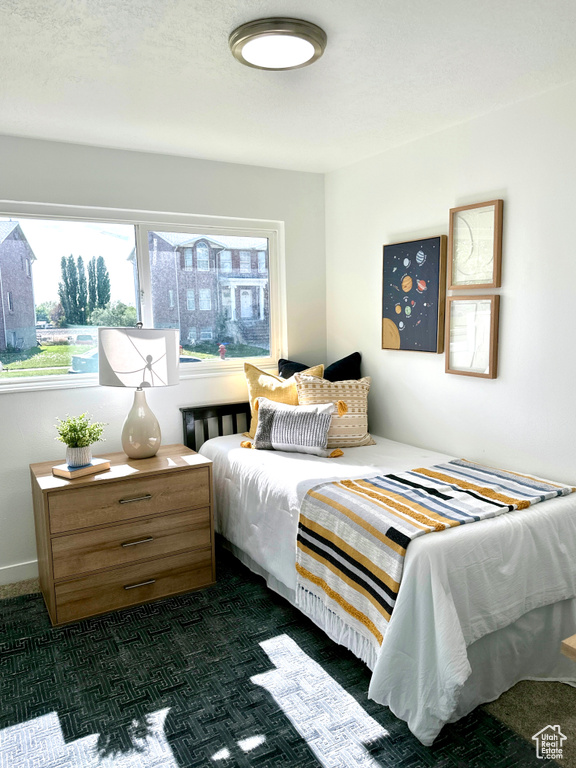 Bedroom featuring dark carpet